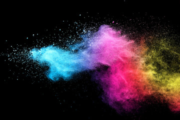 Wall Mural - explosion of colored powder isolated on black background.