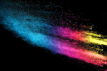 Wall Mural - explosion of colored powder isolated on black background.