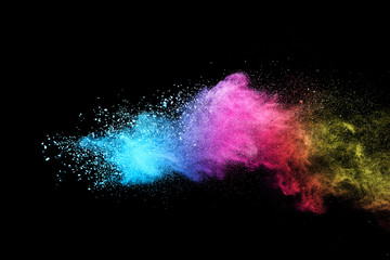 Wall Mural - explosion of colored powder isolated on black background.
