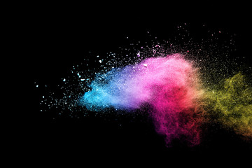 Wall Mural - Explosion of colored powder isolated on black background. 