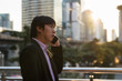 © Blanscape - Korean businessman phone call in city at sunset