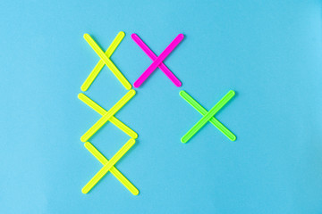 figures from counting sticks in the form of crosses on a blue background