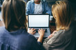 © Rymden - Mockup image of a woman using laptop with blank screen on wooden table