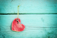 Bronze Key And Red Wooden Heart Hanging On Antique Teal Blue Old Wood Door. Valentines Day