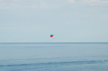 Parachutist Soaring Over The Sea.  Parasailing.  Leisure