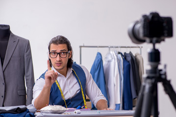 Young male tailor recording video for his blog