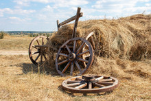 Old Broken Wooden Cart With Hay. Beautiful Summer Day.