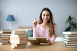 © BestForYou - Smiling student girl at the table with a lot of books. Back to school.