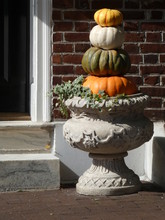 Outdoor Autumn Decoration With Four Pumpkins In Different Colors And Sizes
