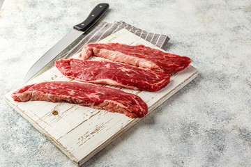 Wall Mural - Raw steak with spices on wooden cutting board