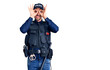 © Krakenimages.com - Young handsome man wearing police uniform doing ok gesture like binoculars sticking tongue out, eyes looking through fingers. crazy expression.