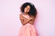 © Krakenimages.com - African american child with curly hair wearing princess crown hugging oneself happy and positive, smiling confident. self love and self care