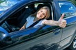 © Krakenimages.com - Young beautiful blonde woman smiling happy with thumb up doing ok sign sitting at the car