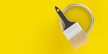 Paintbrush On Top Of Silver Paint Bucket With Yellow Paint On Yellow Background, Home Renovation Concept Flat Lay Top View From Above With Copy Space