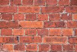 Fototapeta  - Background bricks wall. Texture with red bricks. Masonry with bricks of different sizes. Grounge abstract texture or background. Background from a brick wall of a building.