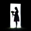 Silhouette of a girl holding flowers.
