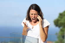 Angry Woman Shouting Calling On Phone In A Balcony