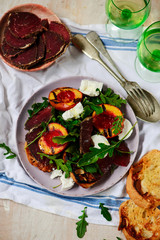 Poster - Grilled peaches, goat cheese, and bresaola salad..