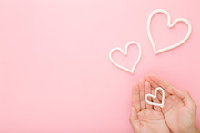 Young Woman Palms And White Heart Shapes On Pink Table Background. Pastel Color. Love And Happiness Or Care About Hands Skin Concept. Empty Place For Inspirational Text, Quote Or Sayings. Top View.