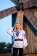 © Nomad Pixel - Blonde European girl in traditional Romanian folk costume with embroidery. Romanian folklore.