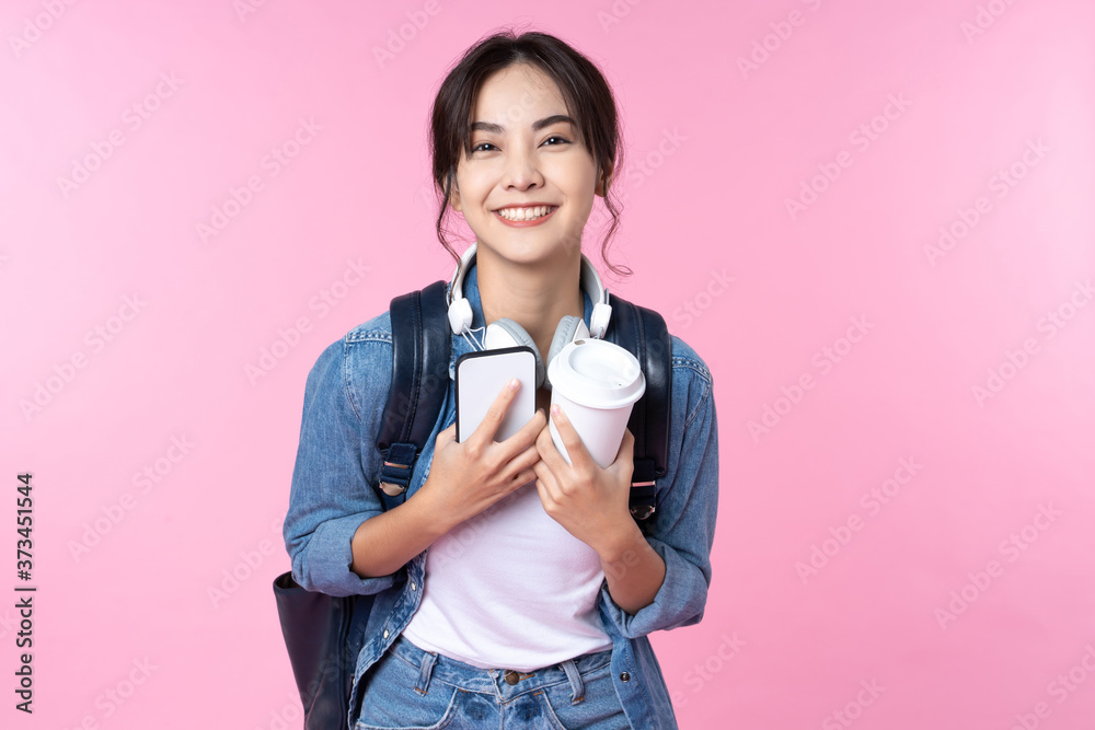 Portrait of young Asian woman student standing with smartphone coffee ...