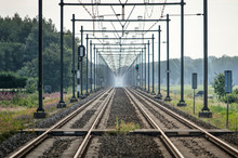 Long Straight Railway Line Between Zwolle And Meppel In The Netherlands, With Converging Lines Disappearing In A Distant Haze