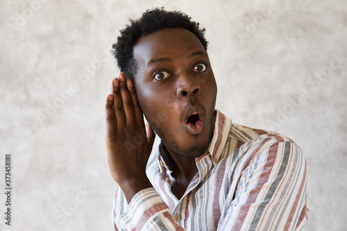 Cuadros en Lienzo Emotional curious young Afro American man with mouth gaped open expressing surpr