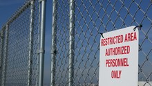 Restricted Area, Authorized Personnel Only Sign In USA. Red Letters, Keep Off Warning On Metal Fence, United States Border Symbol. No Trespassing Notice Means Violators Will Be Prosecuted By US Law
