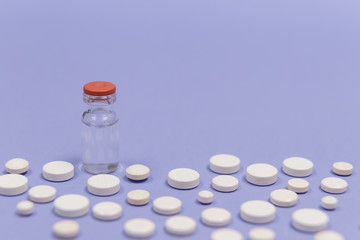 Pill and injection bottle on a purple background