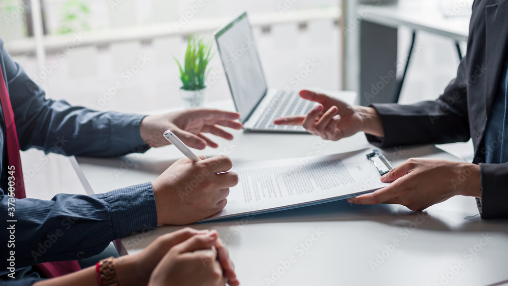 Signing a business contract. A group of business people at the meeting and sign a together business investment agreement. - obrazy, fototapety, plakaty 