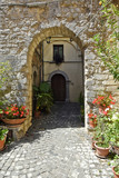 Fototapeta Uliczki - A narrow street among the old houses of Vallecorsa, a medieval village in the lazio region.