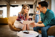 © NDABCREATIVITY - Smiling business people talking and working together in bright office