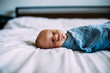 © Cavan Images - Close up of newborn sleeping on bed alone