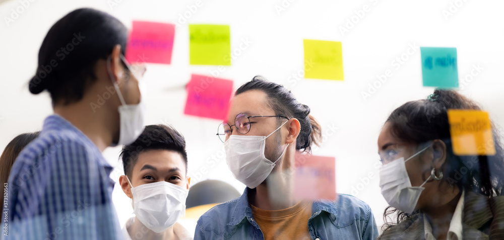 Interracial business team wear face mask brainstorm at new normal office Panorama - obrazy, fototapety, plakaty 
