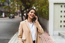 Beautiful Hispanic Woman Taliking On The Phone In The Street