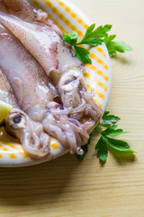 Wall Mural - fresh squid with lemon on the plate