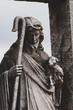 Dark contrast image of Jesus figure holding baby lamb and Shepard’s crook/staff