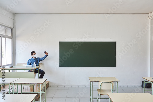 Professor sitting in an empty classroom.
