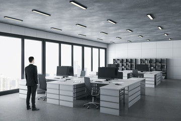 Poster - Businessman standing in in modern coworking office interior