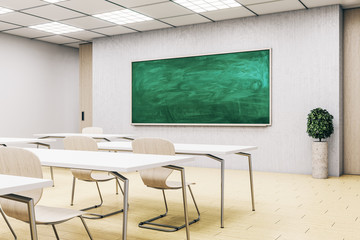 Bright classroom interior with empty green blackboard