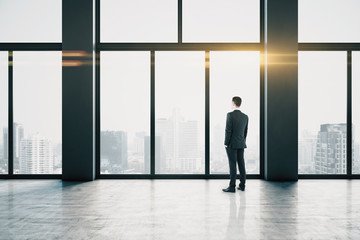 Poster - Thoughtful businessmen in empty concrete hallway interior