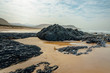 Photograph of a stunning black rock on Nature's Valley beach in the Western Cape, South Africa.