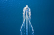 Drone view of a boat sailing. Top view of a white boat sailing to the blue sea. Motor boat in the sea. Travel - image.