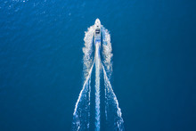 Drone View Of A Boat Sailing. Top View Of A White Boat Sailing To The Blue Sea. Motor Boat In The Sea. Travel - Image.