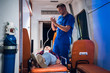 © Anna Kosolapova - Medical student having an exam, preparing to give an oxygen mask to his patient in an ambulance car.