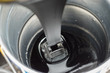 Glutinous Asphalt Bitumen slowly drop into a metal bucket