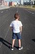 © Natallia Lipchanka - boy is standing on  road, safety of children on the roadway, traffic rules concept, deadly threat
