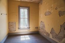 Eerie Interior Room In An Abandoned Home In Bannack Ghost Town Montana, With Peeling Paint, Exposed Walls And An Old Window