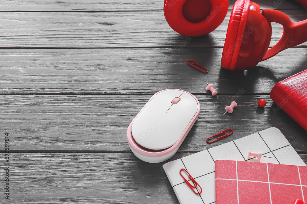 Modern PC mouse, headphones and stationery on table