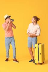 Canvas Print - Couple of gay tourists on color background